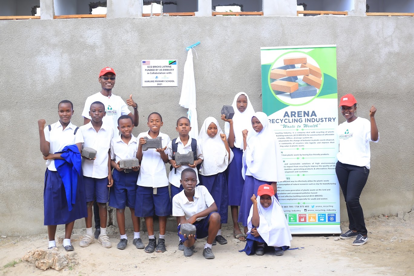 Hellena Tanzania with the school latrine made with recycled ecobricks