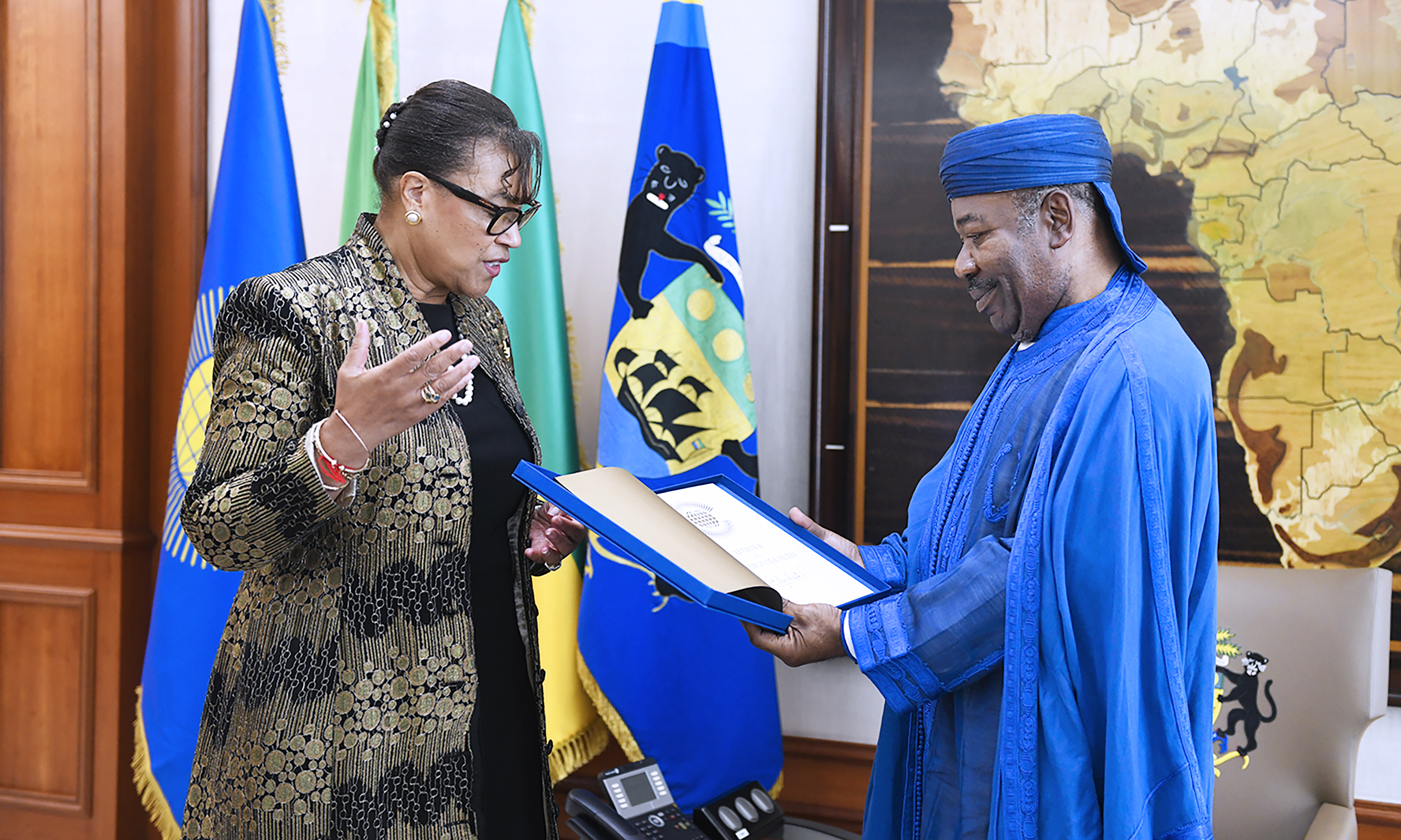 Secretary-General giving the President of Gabon the Commonwealth Charter