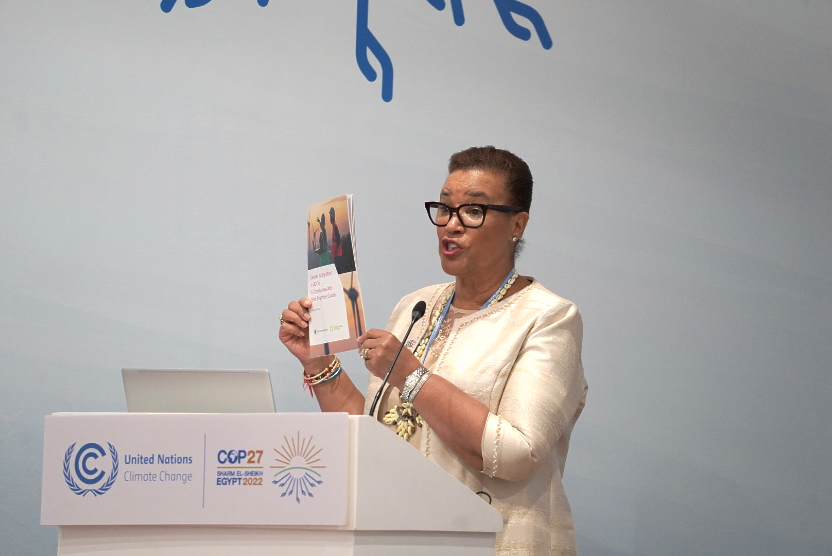 Secretary-General holding up the Guide Book