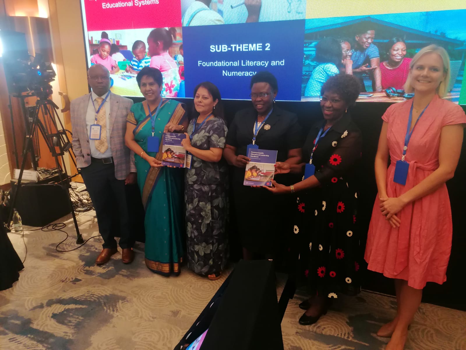 Participants holding the new Commonwealth Educational Leadership Handbook