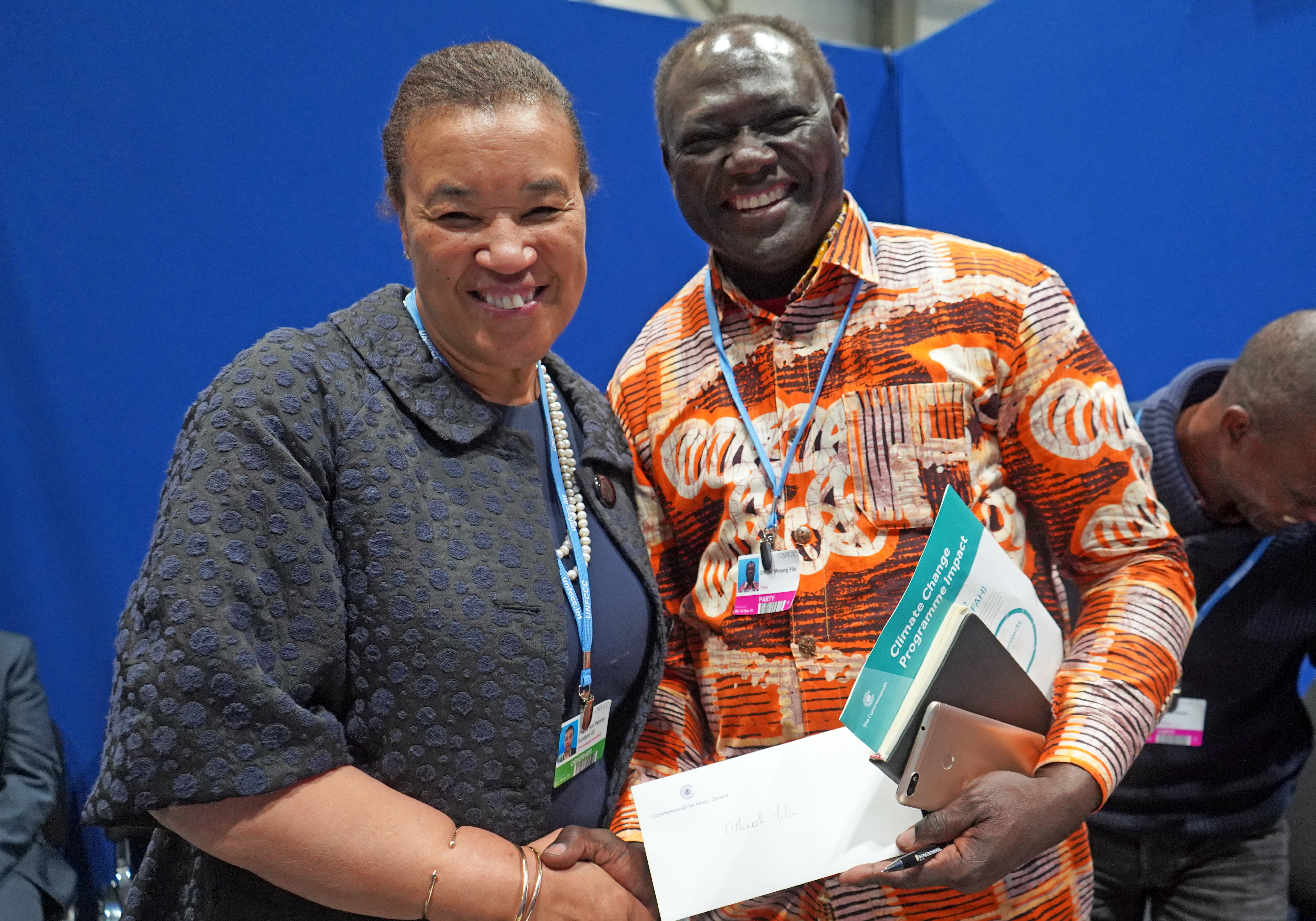 Commonwealth Secretary-General, the Rt Hon Patricia Scotland KC greets Commonwealth Climate Finance Adviser for Zambia Dr Othniel Yila in the margins of the UN Climate Change Conference COP25 in 2019.