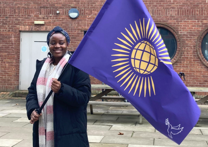 Taibat Hussain from United Kingdom holding the Commonwealth Flag for Peace