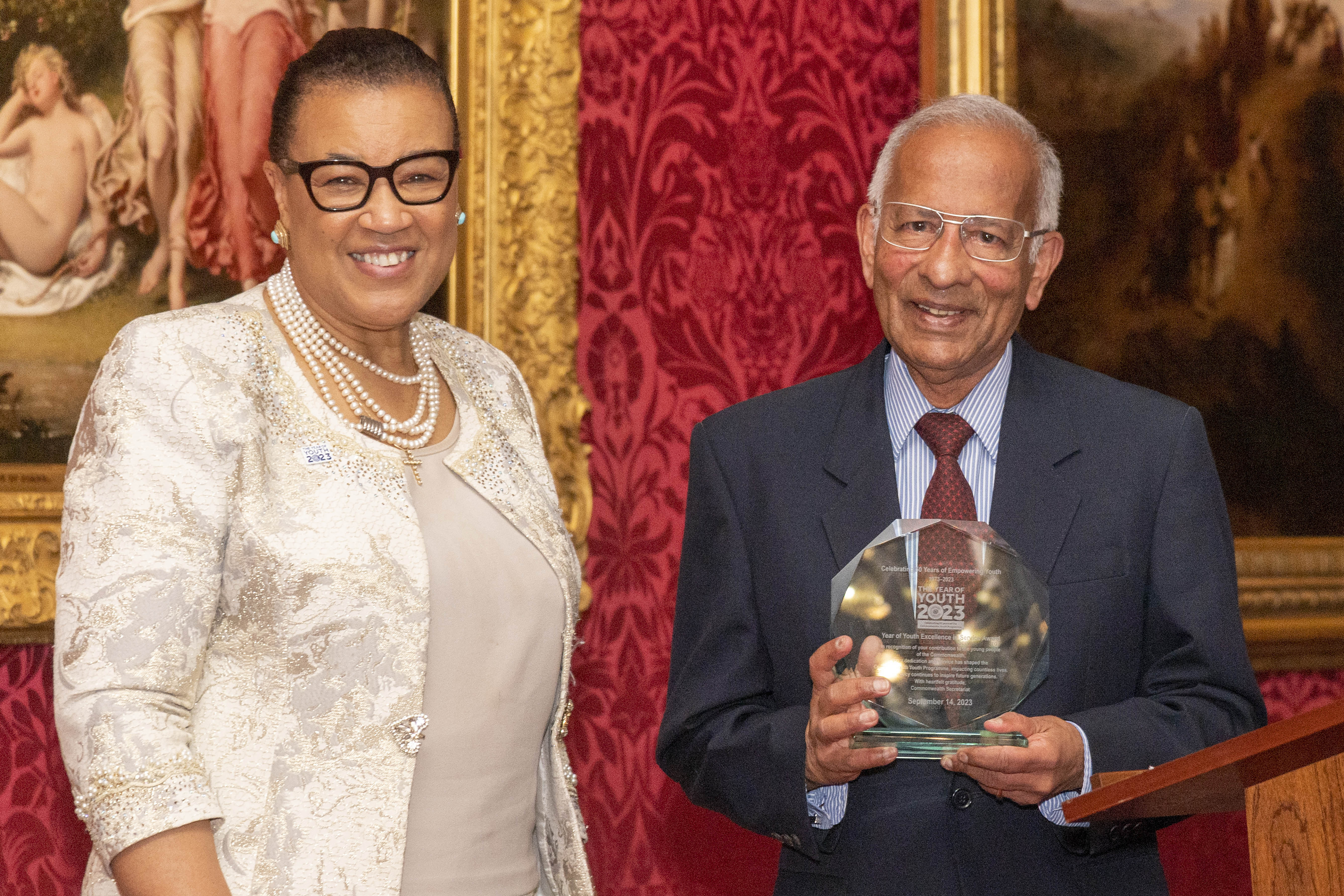 The Commonwealth Secretary-General awarding previous Commonwealth Youth Programme Director Mr Raja Gomez