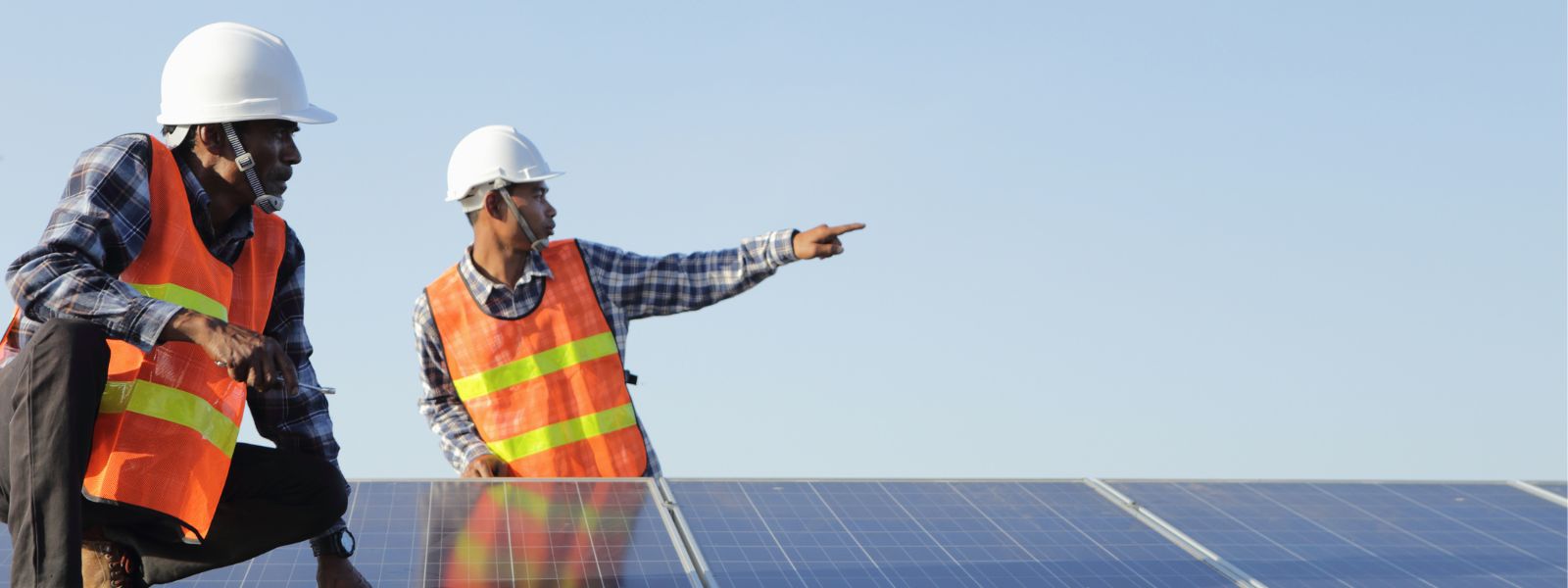 Two engineers checking solar cells
