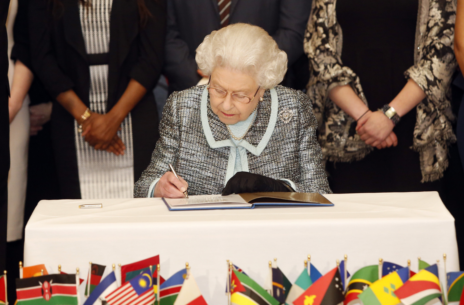 Her Late Majesty Queen Elizabeth II signs the Commonwealth Charter in 2013
