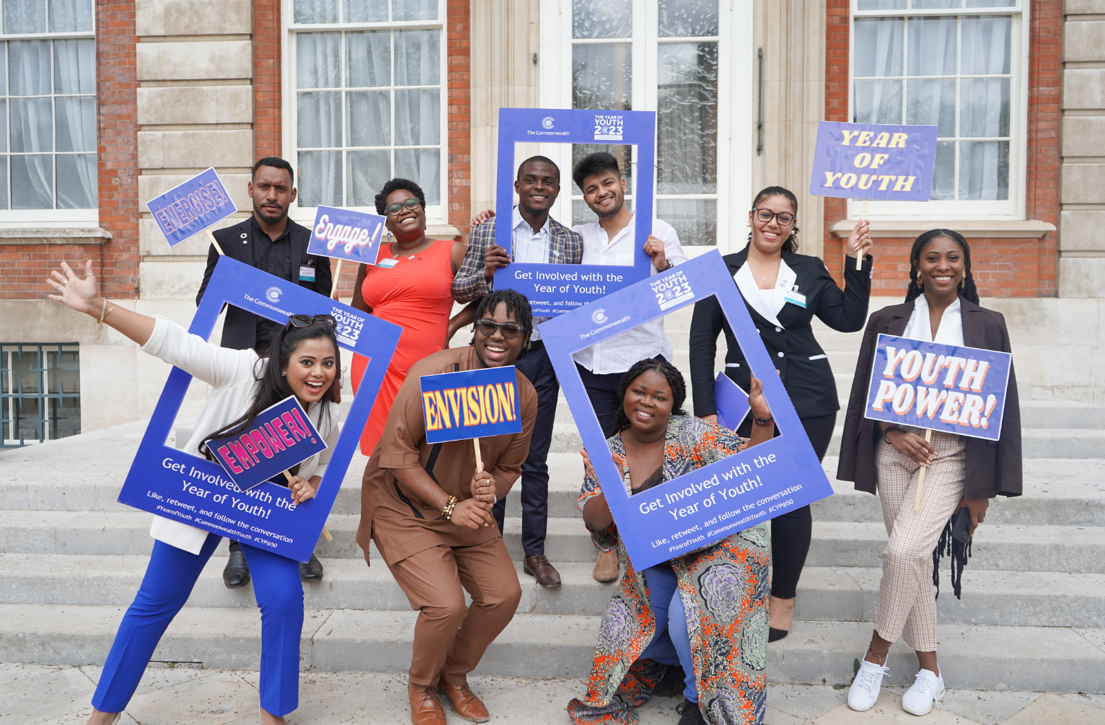 Youth leaders pose with Year of Youth signs at the 10th Commonwealth Youth Ministers Meeting in London