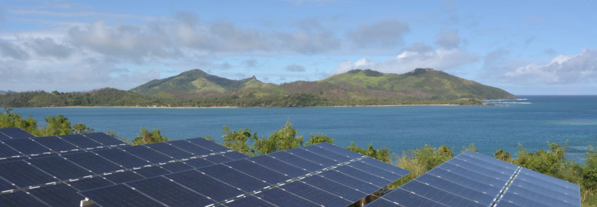 solar pannels in front of island and sea