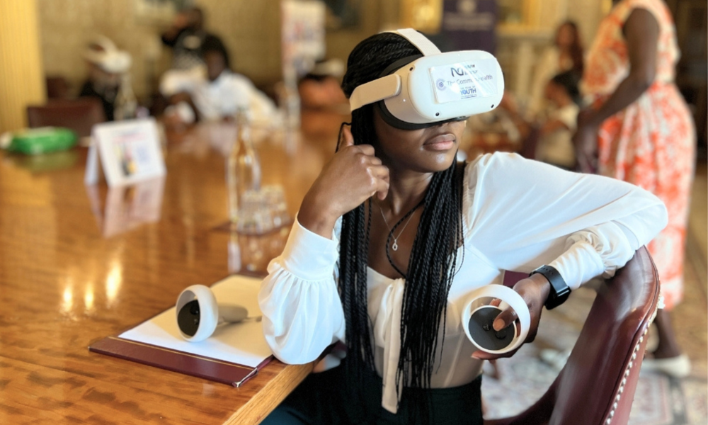 A youth leader explores the new virtual museum through a VR headset