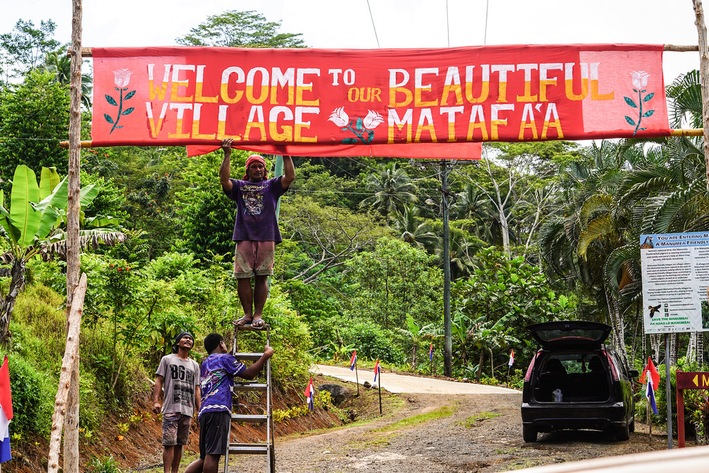 Villagers hang a welcome sign to their village, Matafa'a