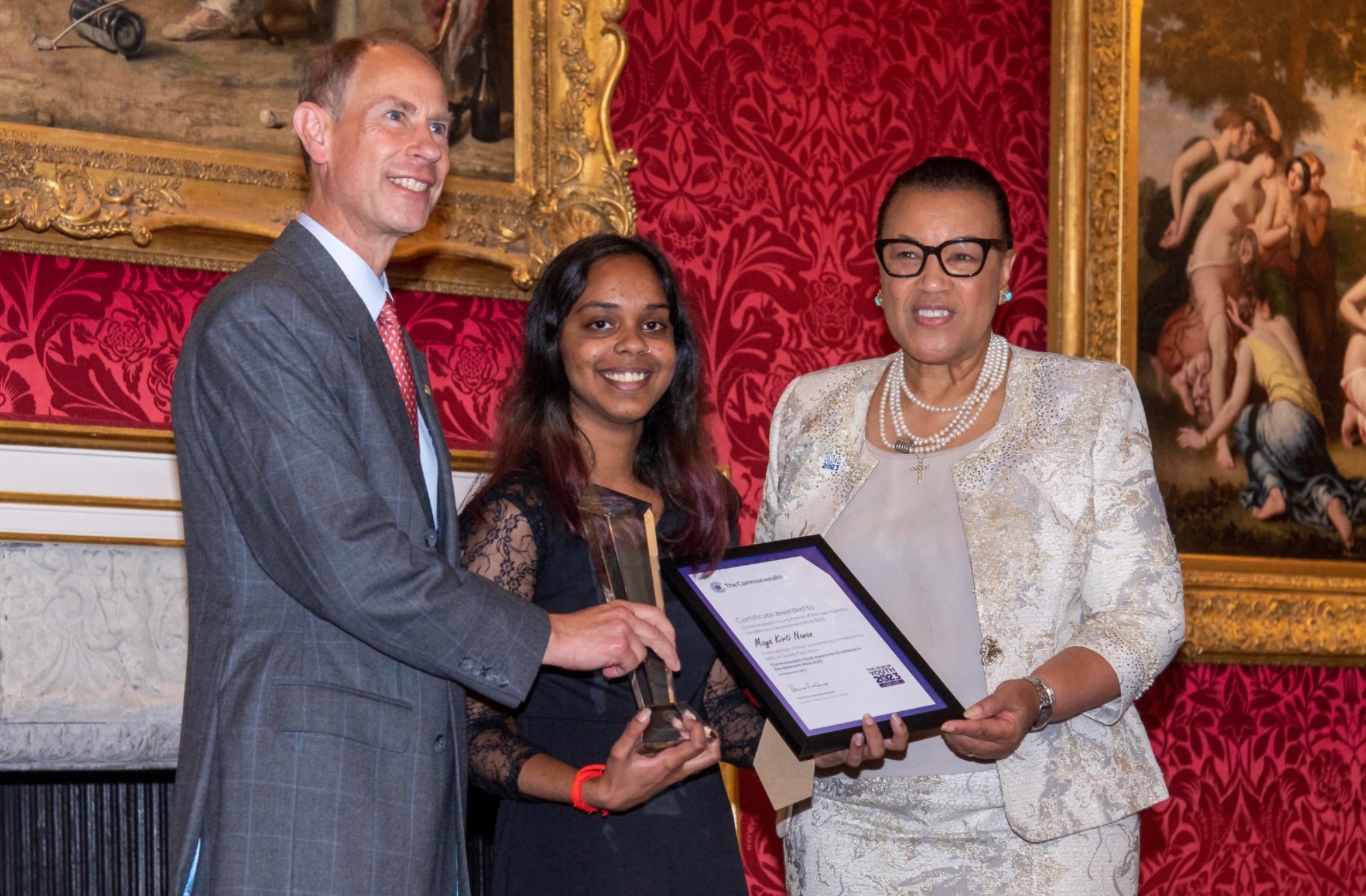 Maya receiving the Commonwealth Young Person of the Year Award, 2023 from His Royal Highness, The Duke of Edinburgh, Prince Edward, and the Commonwealth Secretary-General, the Rt Hon Patricia Scotland KC