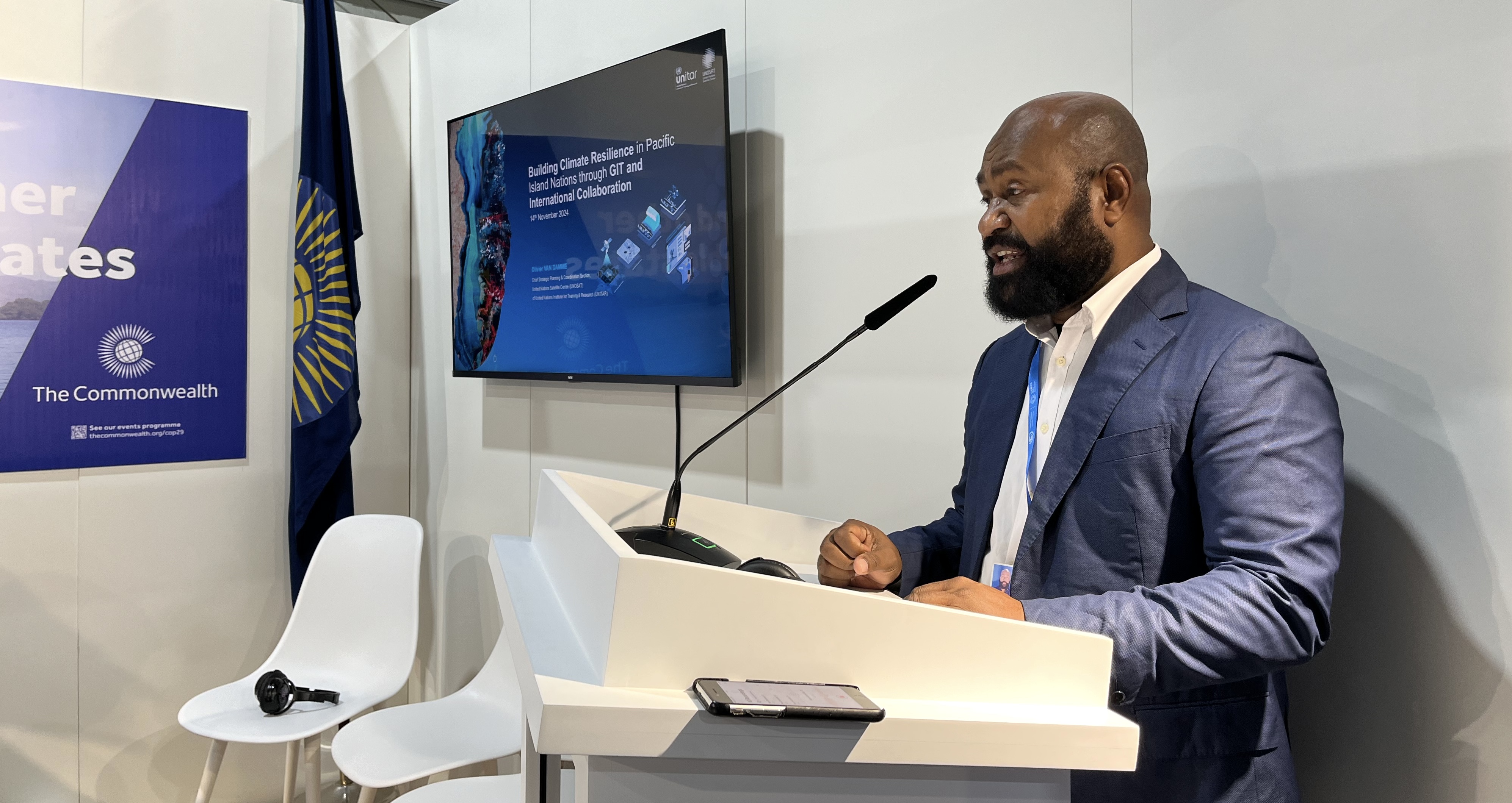 A speaker presents at a side event at the Commonwealth Pavilion