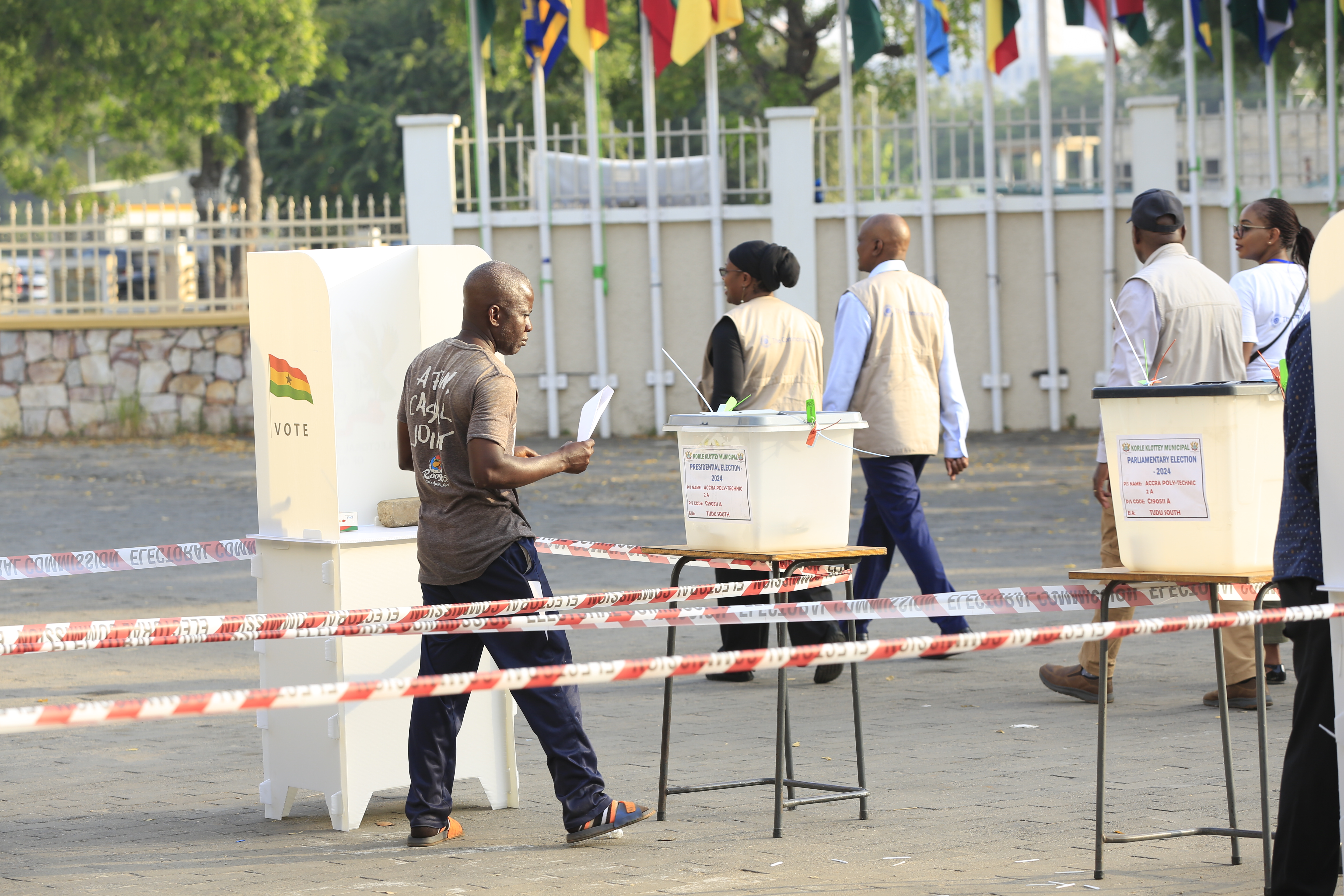 Commonwealth observers watch voting at a polling place in the Ghana elections