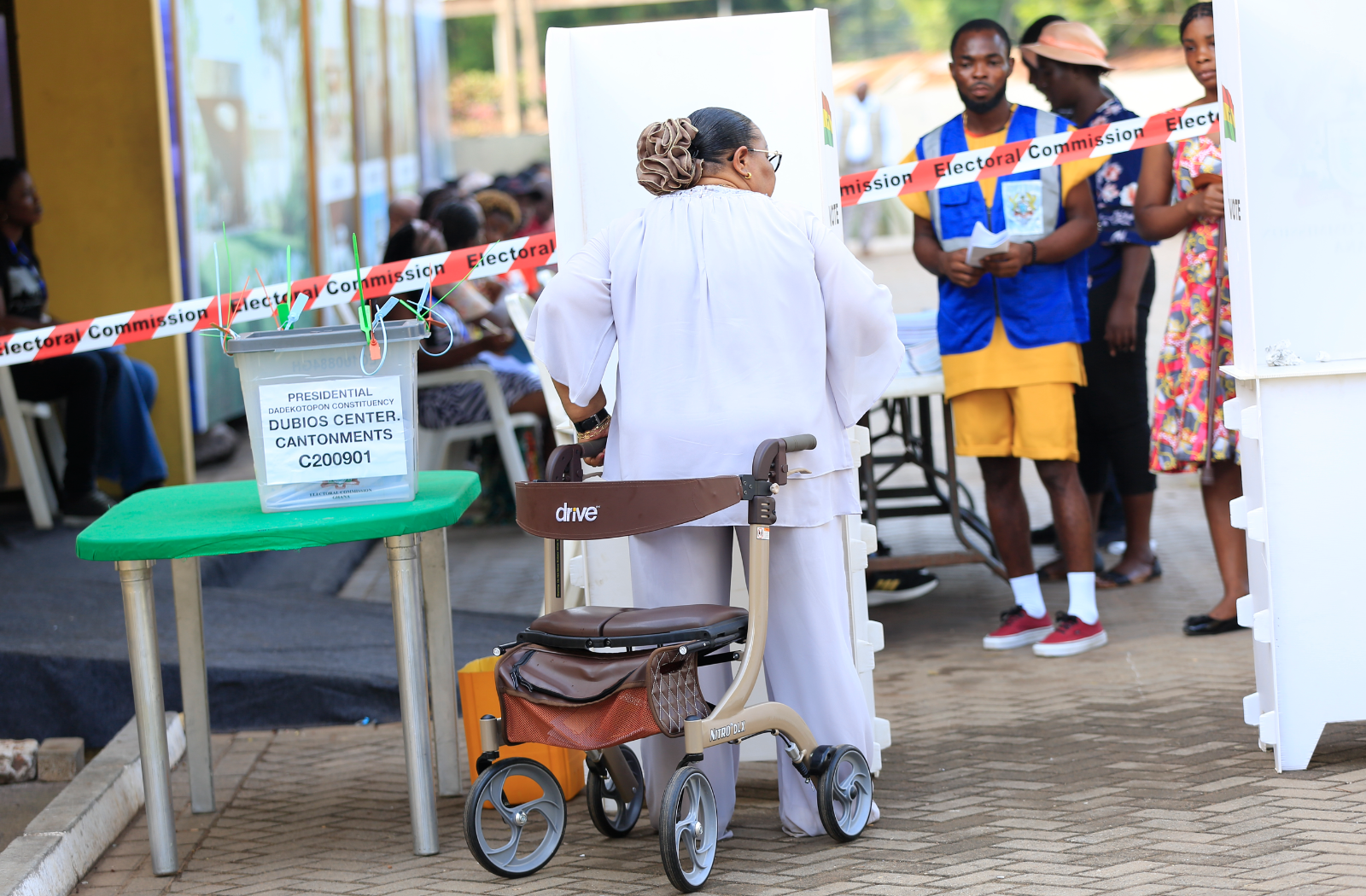 Woman with disability standing up from wheel chair to vote