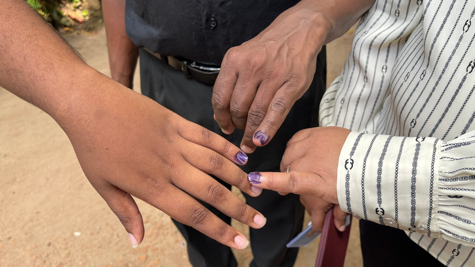 Dilushi and parents inked fingers