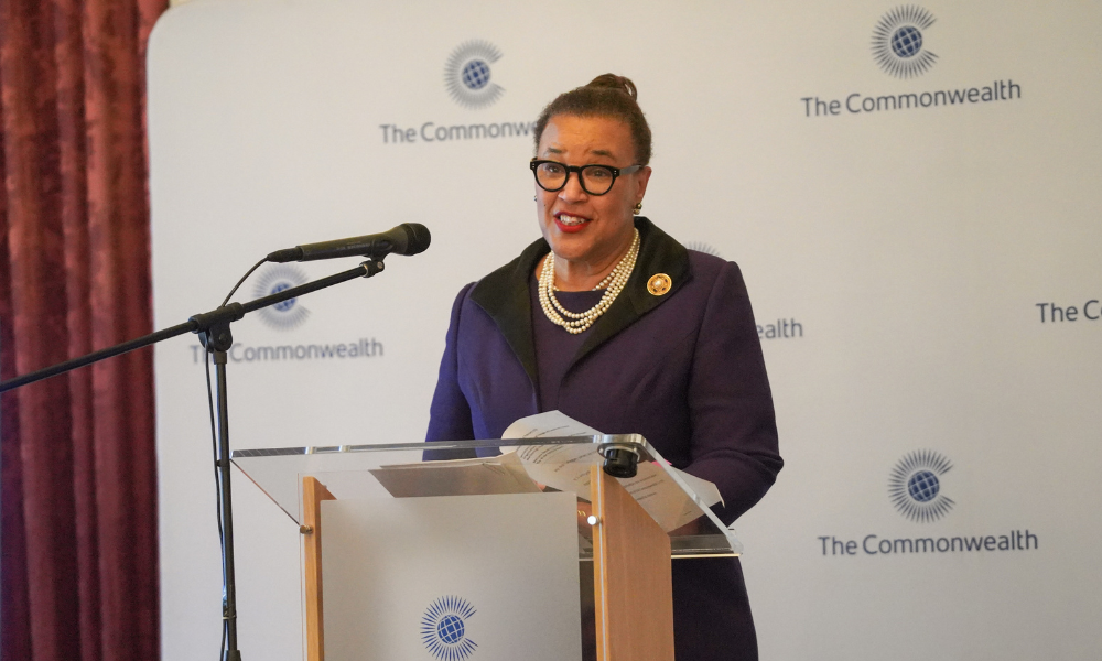 Commonwealth Secretary-General, the Rt Hon Patricia Scotland KC, speaking at the podium at the Luncheon for accredited organisations