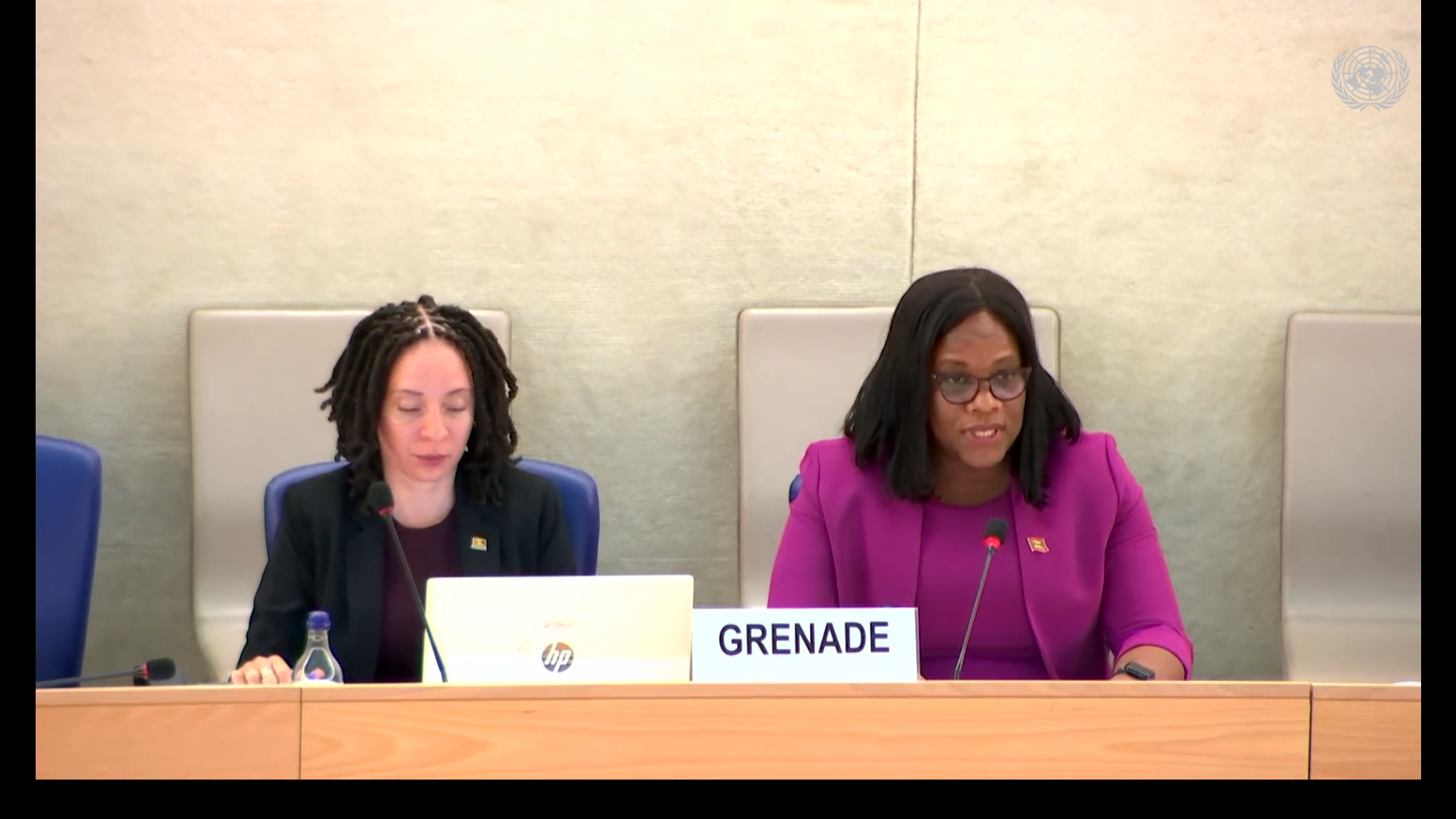 lady sat at a podium speaking into microphone