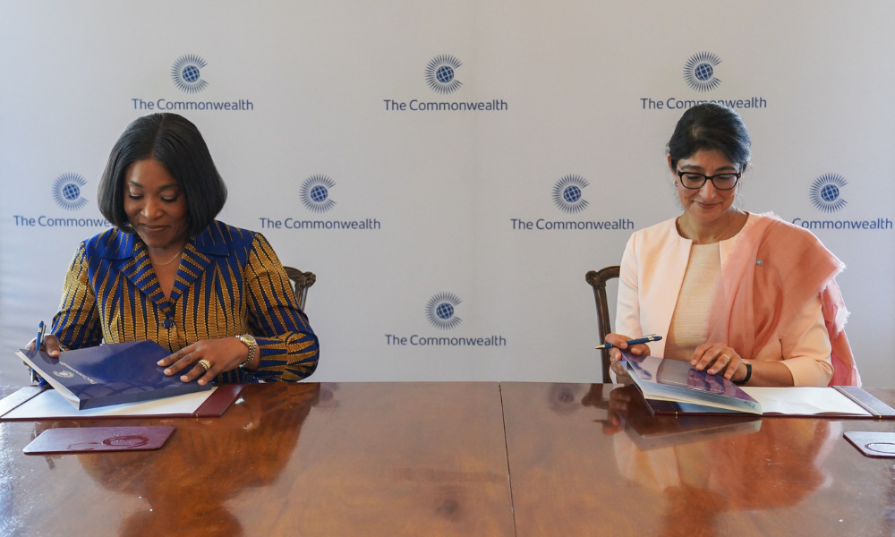 Commonwealth Secretary-General and UNOOSA Director signing the MoU