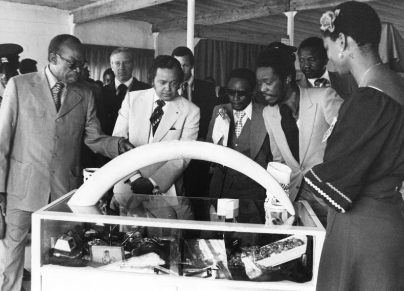 President Khama of Botswana explains a point to the Commonwealth Secretary-General Shridath Ramphal during a visit to one of the stands at a trade fair