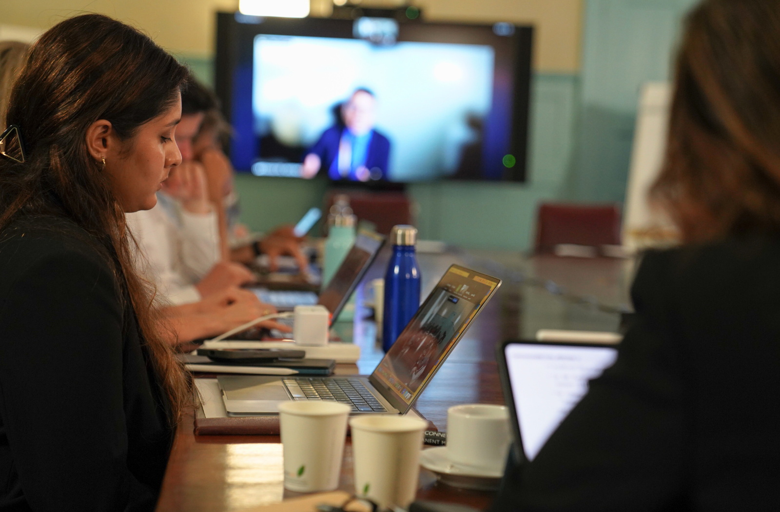 A woman takes notes on her laptop during the roundtable discussion