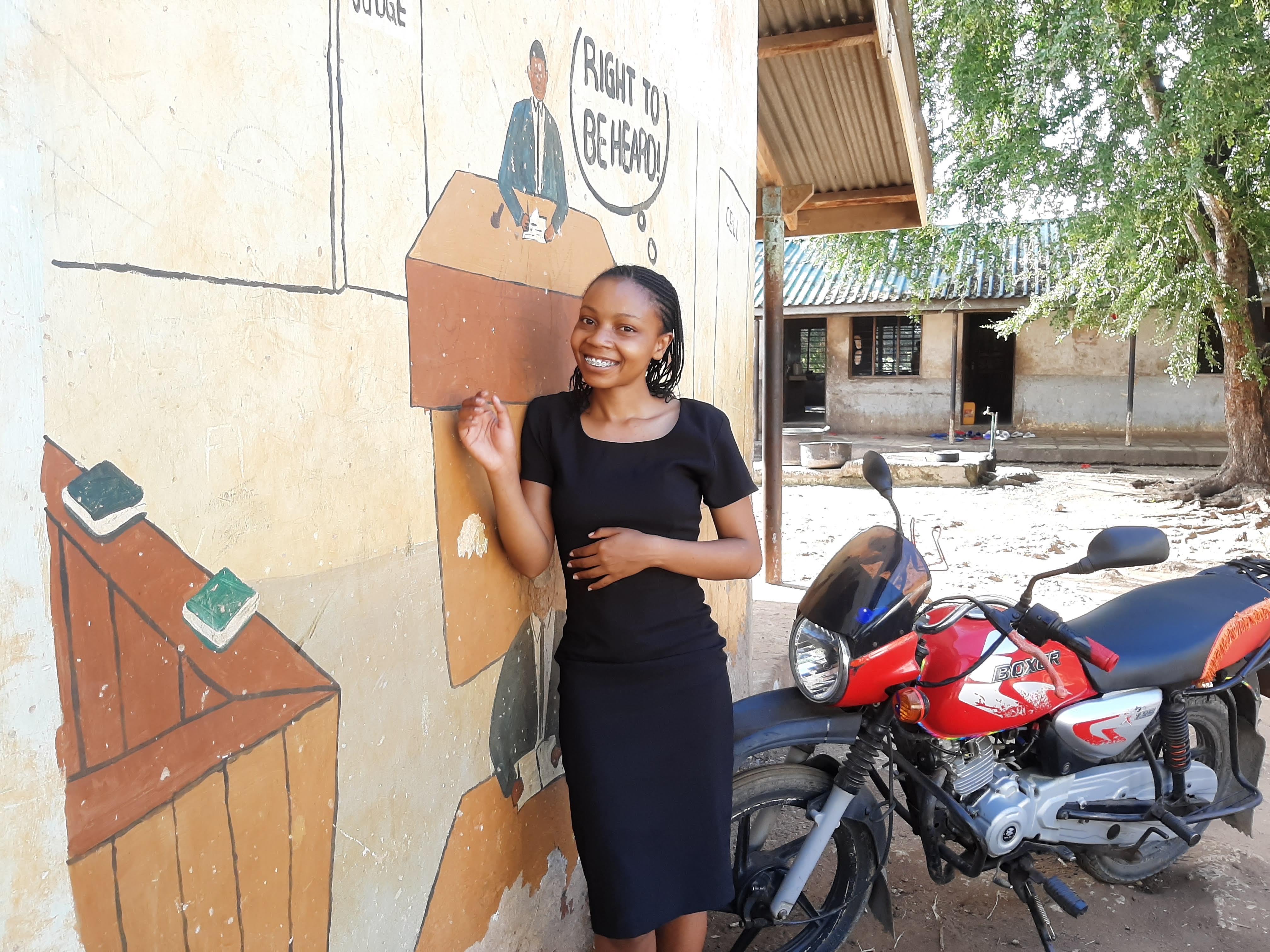 Cynthia standing by a wall