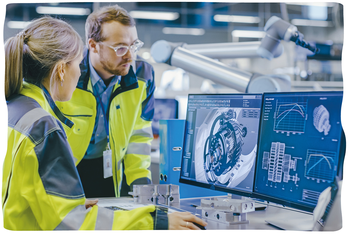 two engineers examining a 3D rendering of a complex machine