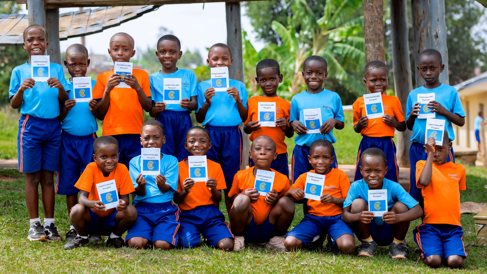 A group photo of children holding their Commonwealth passports