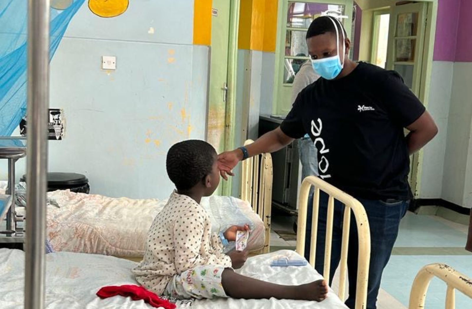Sidney Chahonyo in hospital with a child