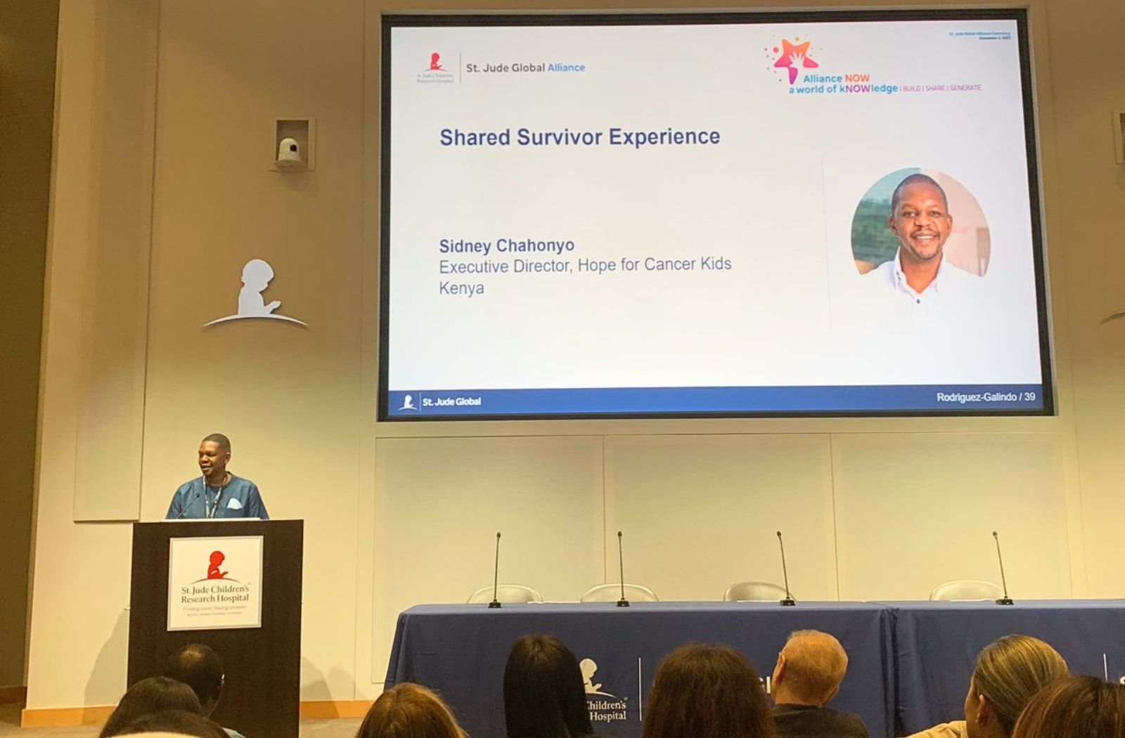 Sidney Chahonyo speaking at a podium during an event