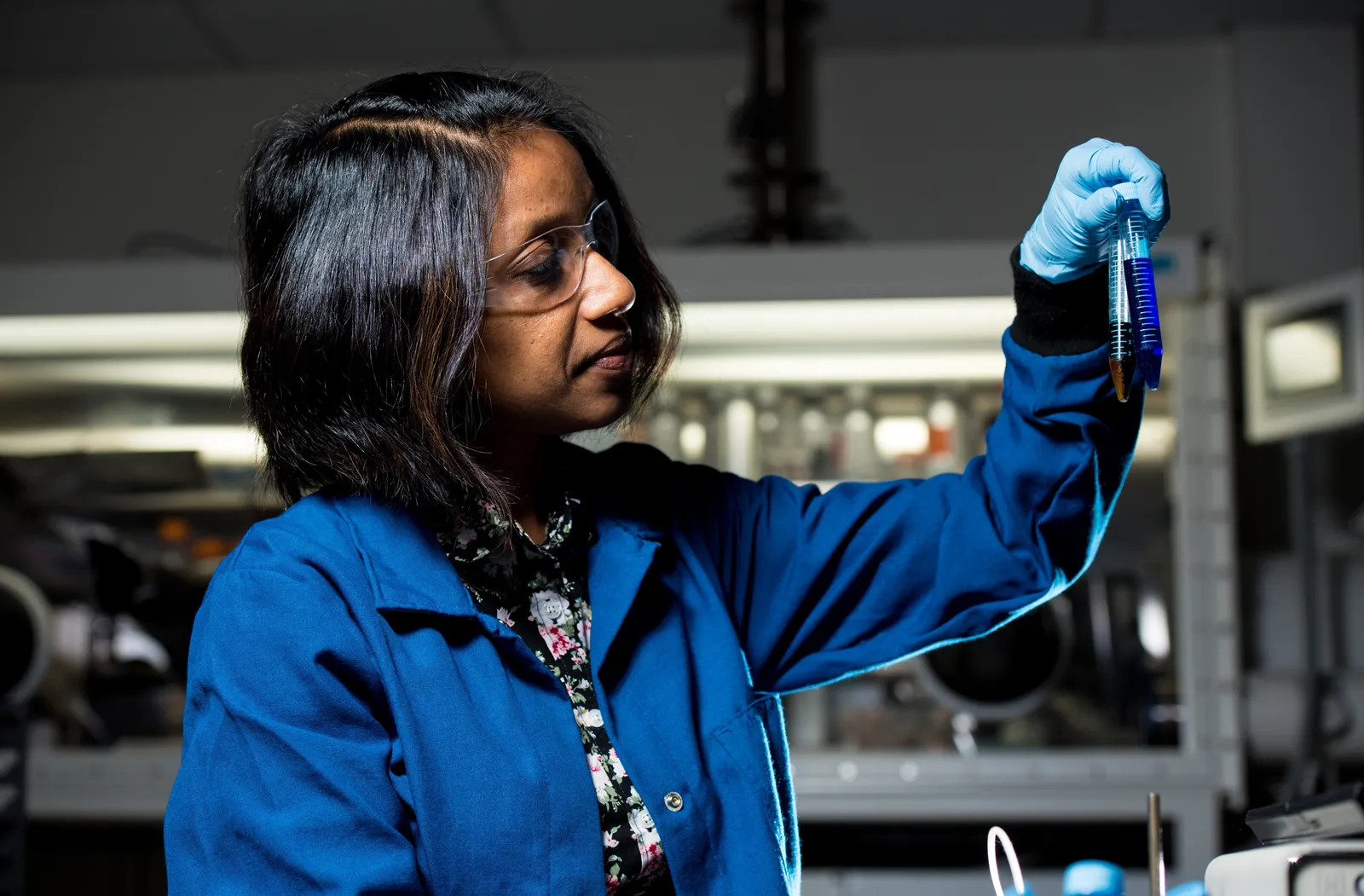 A female scientist holding two test tubes