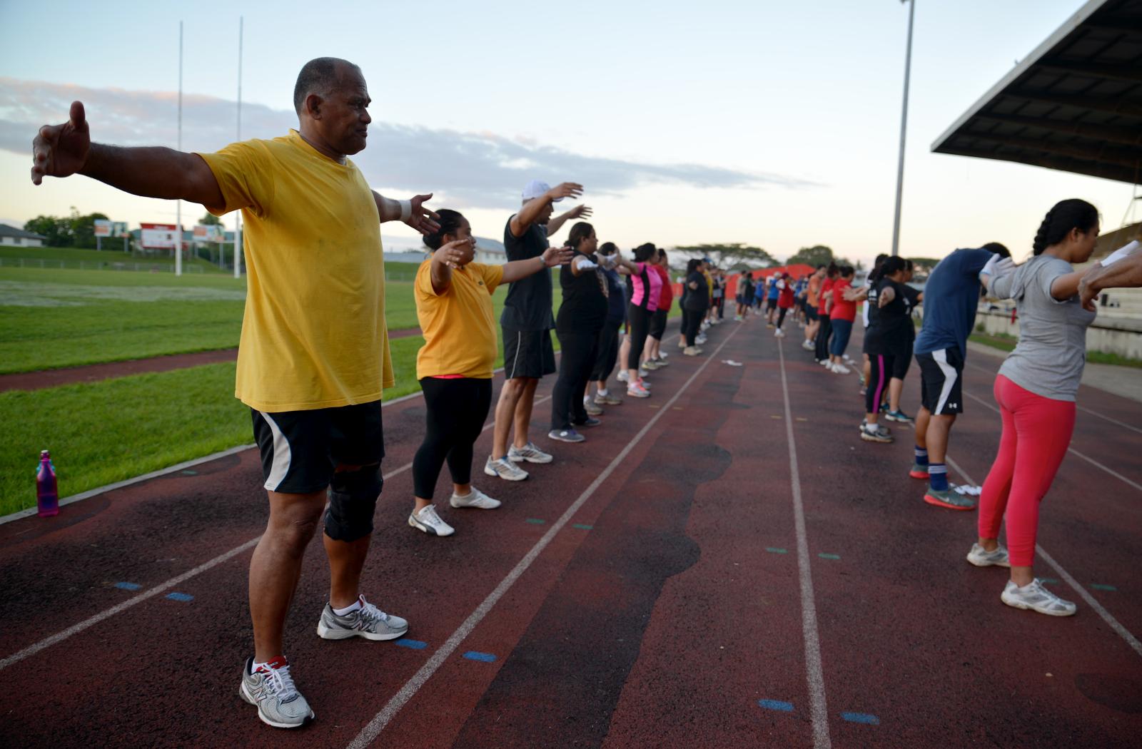 People doing stretches at a sport boot camp