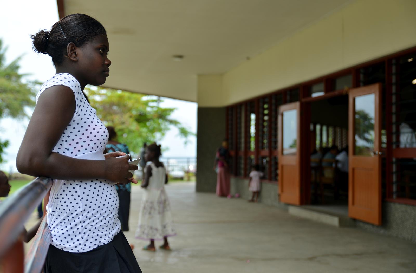 A girl waits for the end of a church service in Solomon Islands 