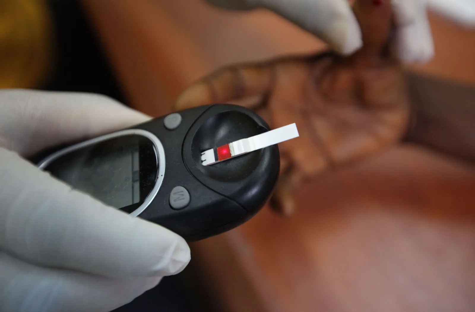 A doctor taking a blood sample from a patient