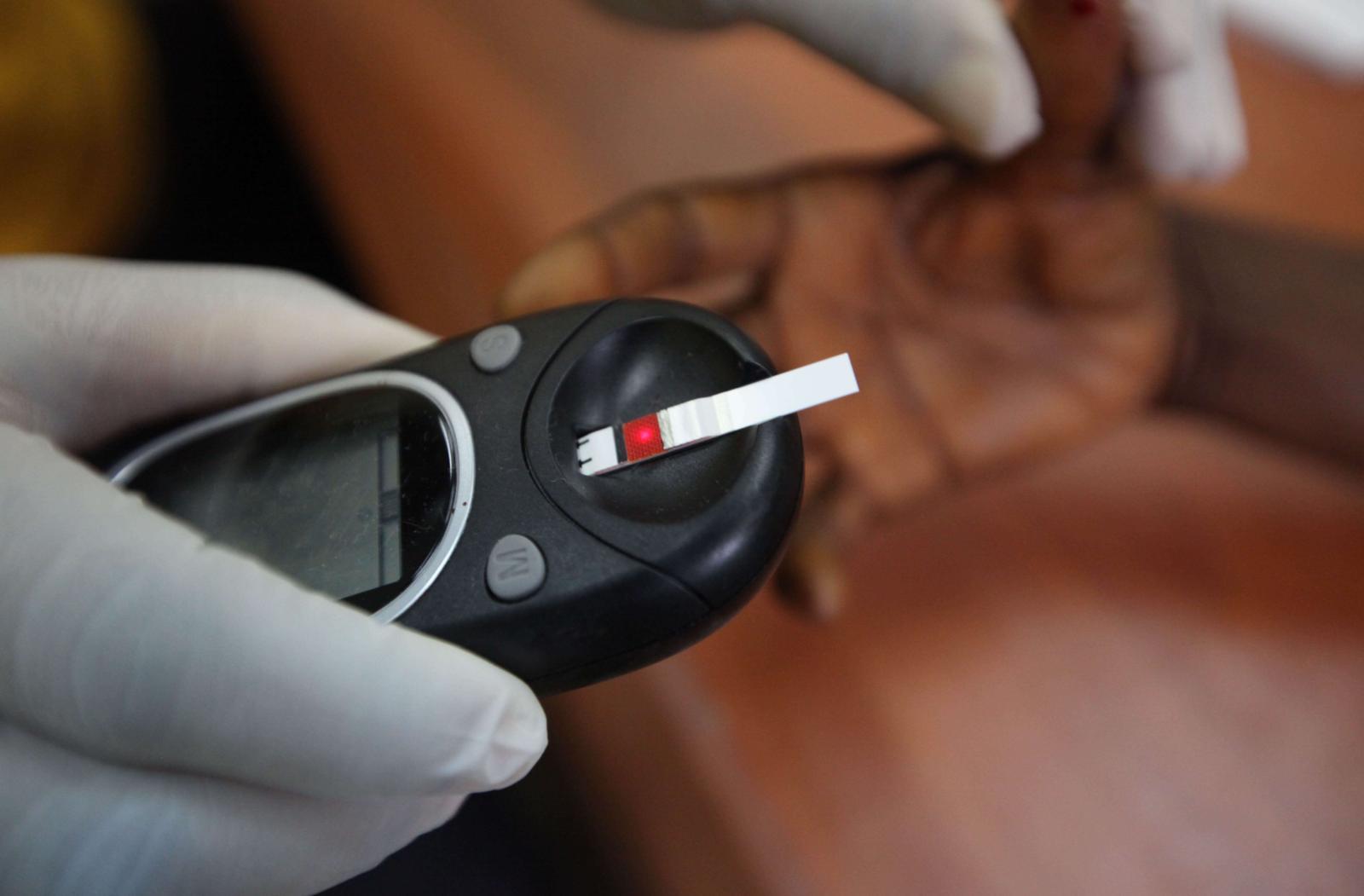 A doctor taking a blood sample from a patient