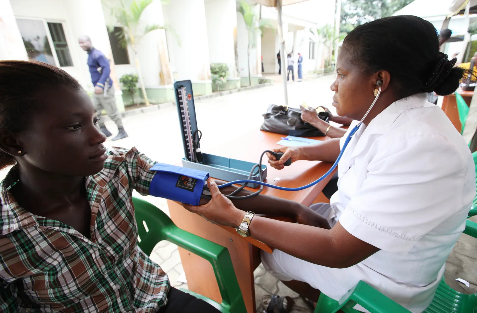 A doctor checks the blood pressure of a patient