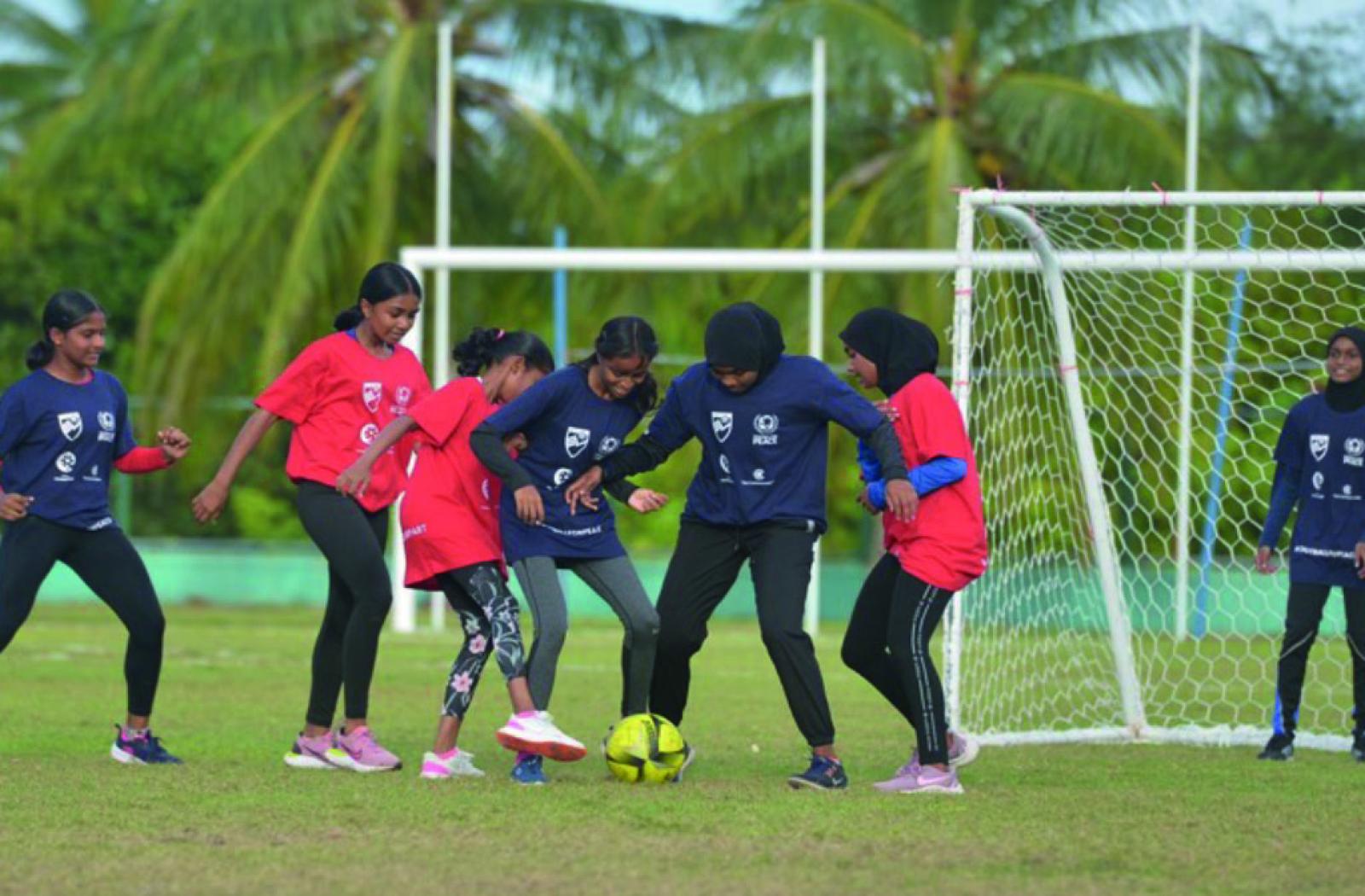 Girls playing football in the Maldives