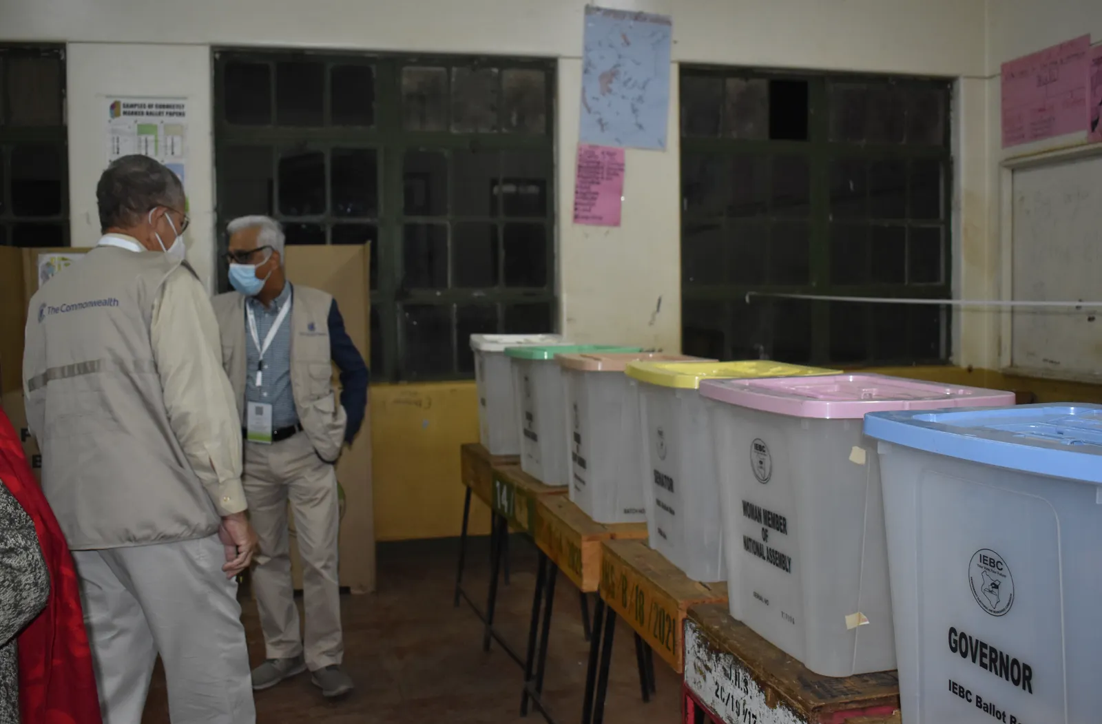 COG members looking at ballot boxs