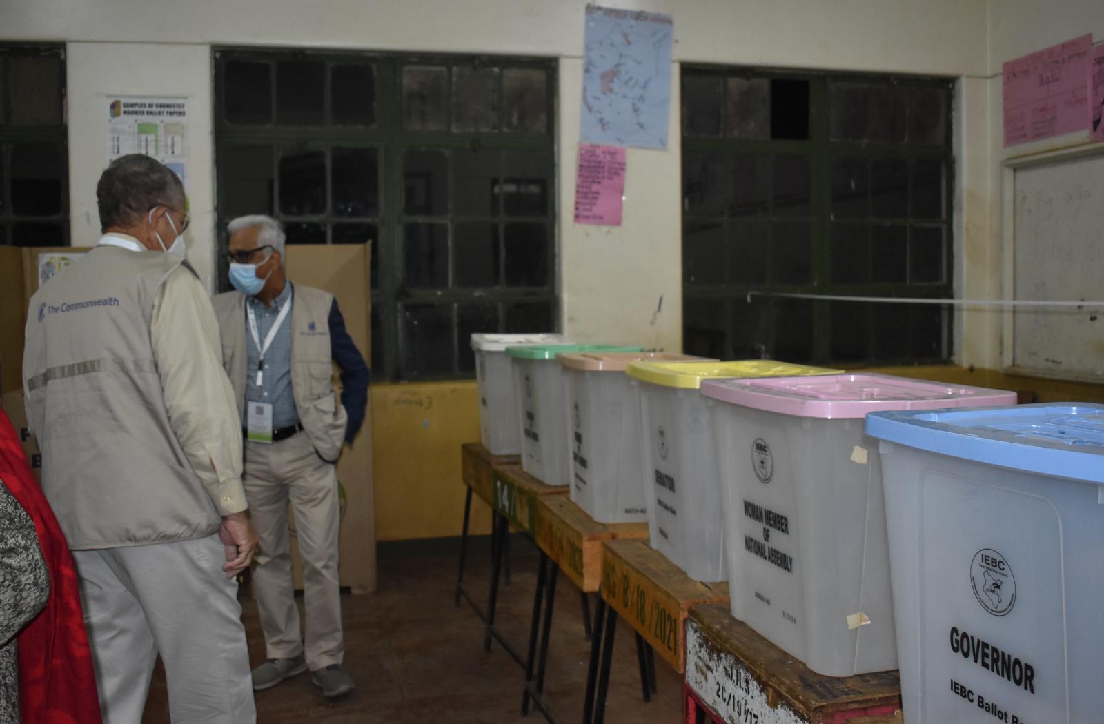 COG members looking at ballot boxs