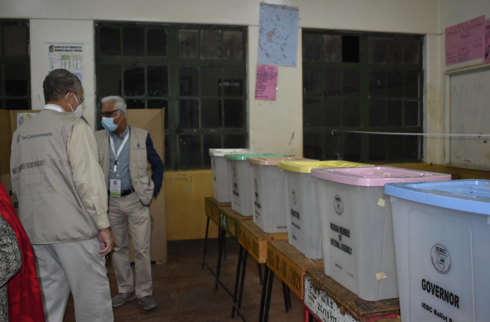 COG members looking at ballot boxs