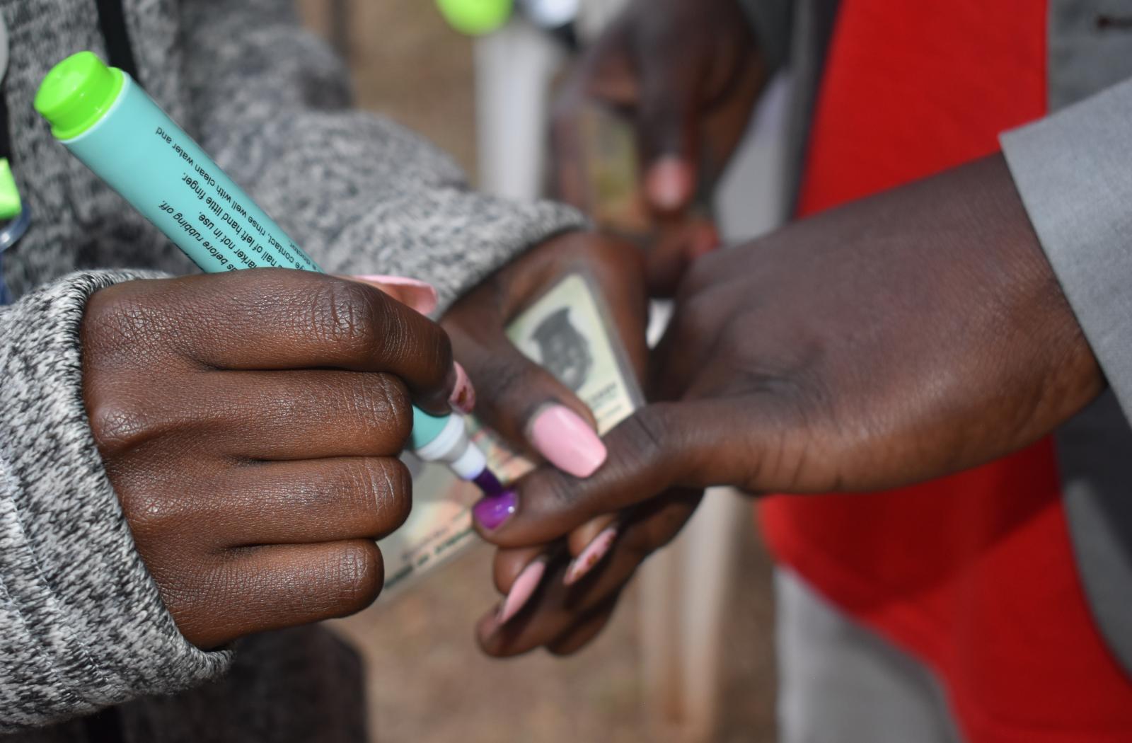 Person getting their finger marked for voting