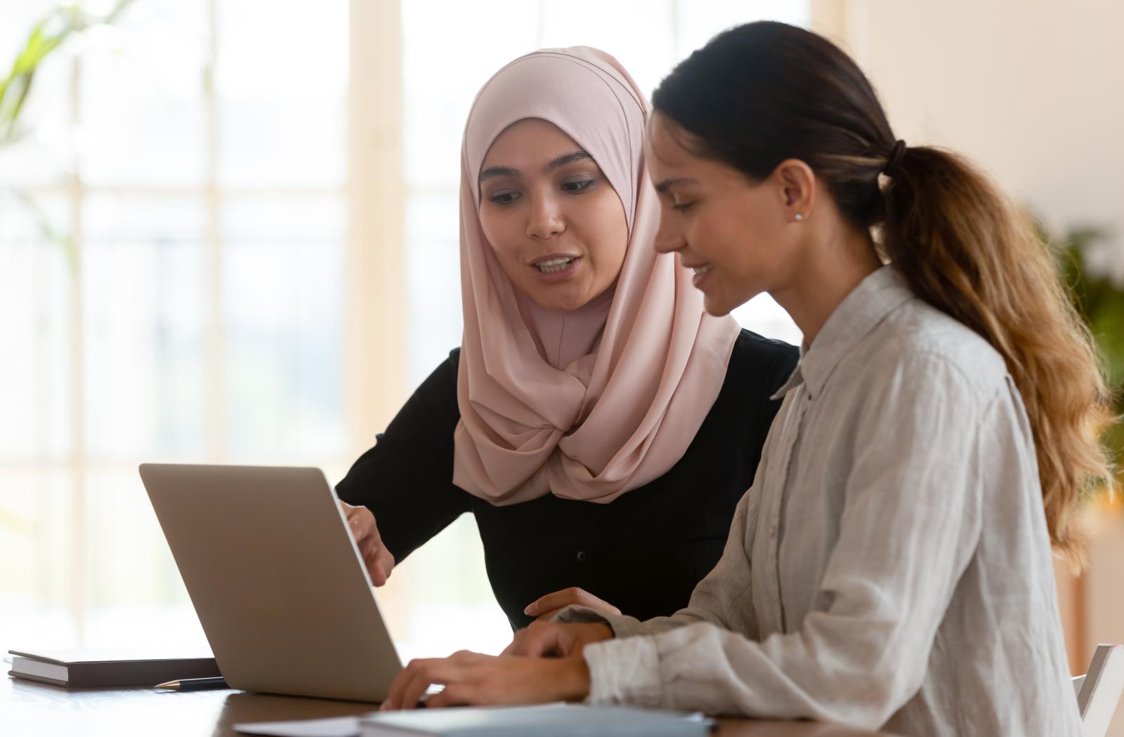 Two woman working on laptop