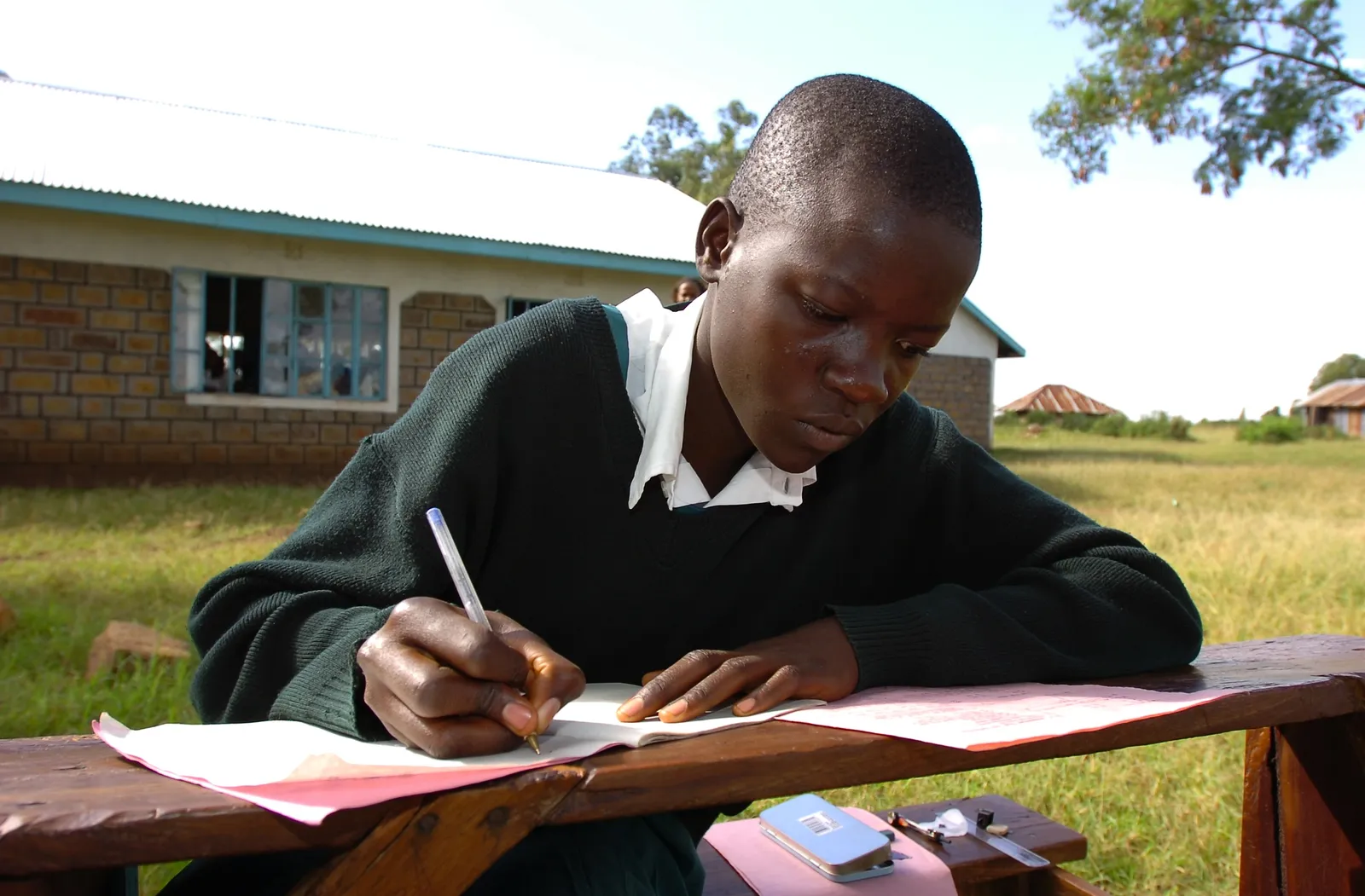 A student writing in their notebook