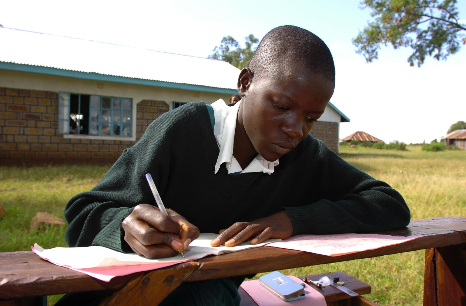 A student writing in their notebook