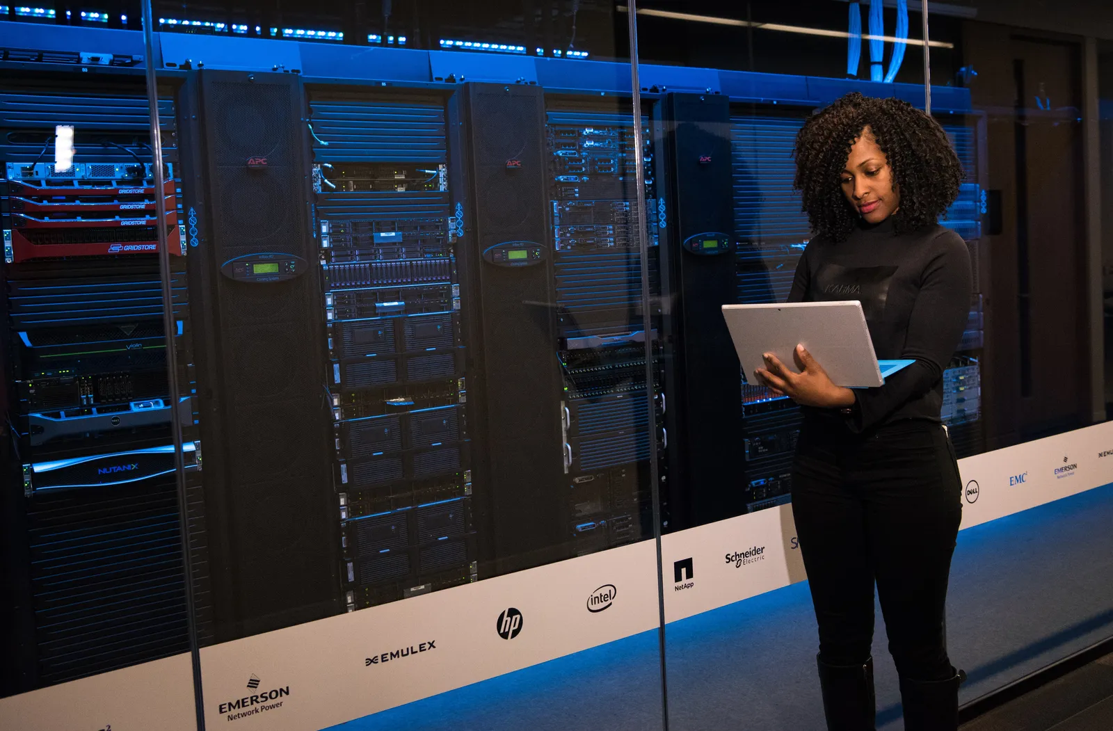 Woman on computer in a server room