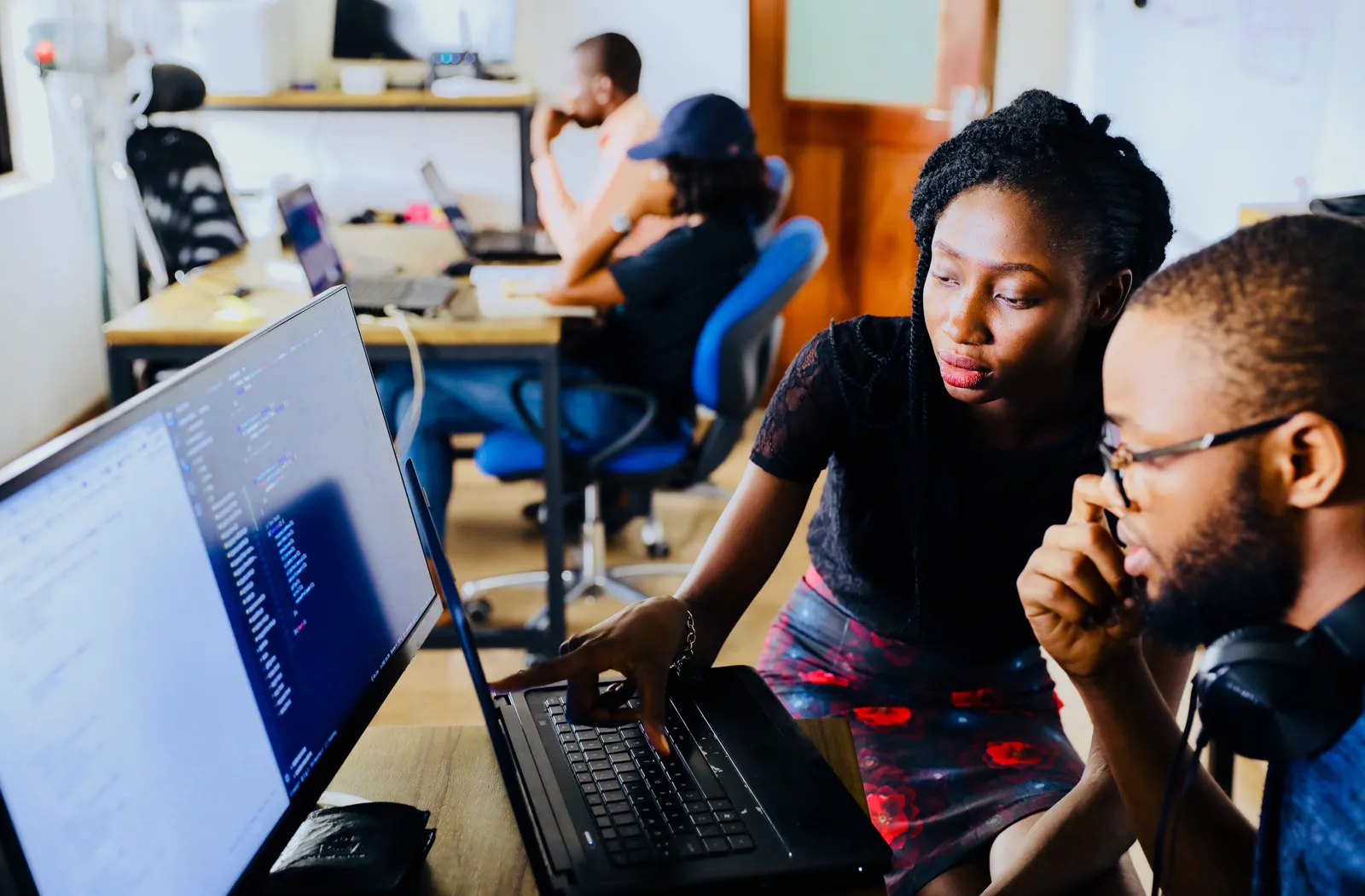 Two people look at a computer screen