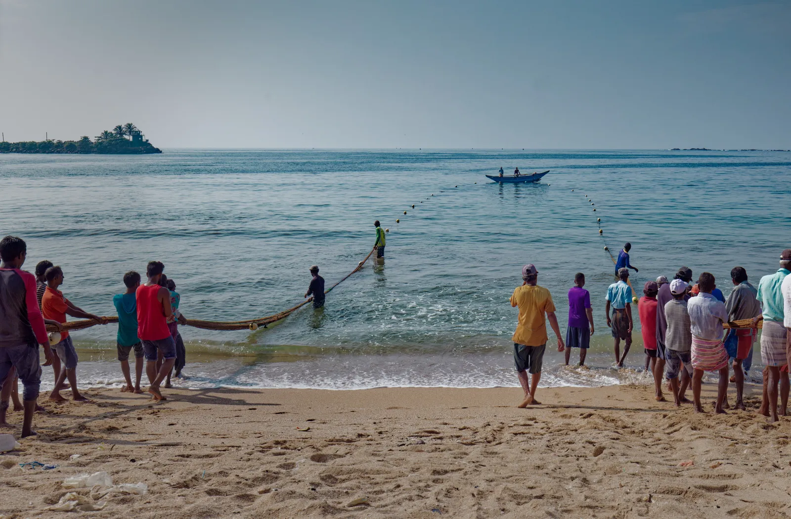 People pull in fishing nets