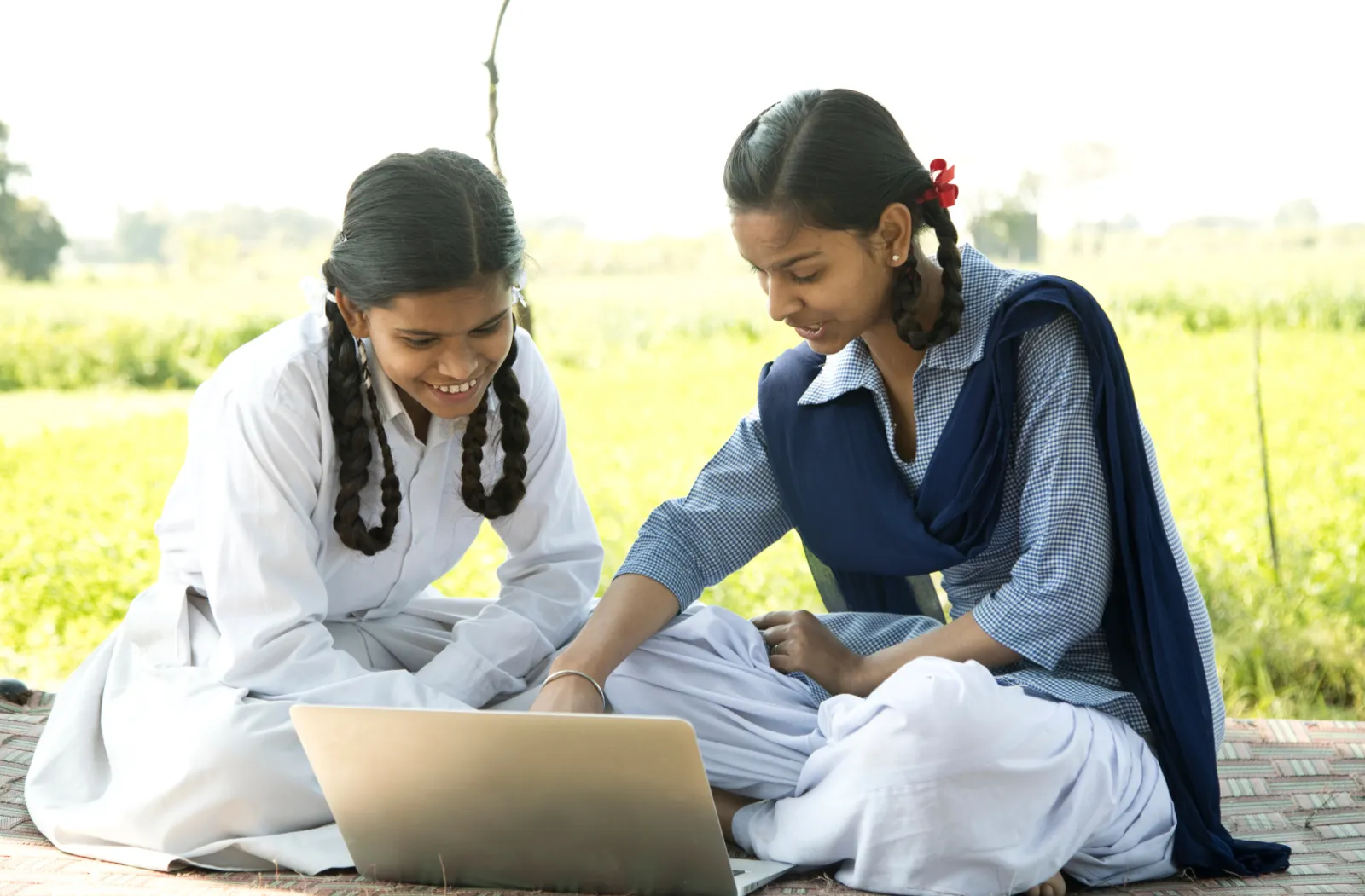Two girls looking at a laptop screen