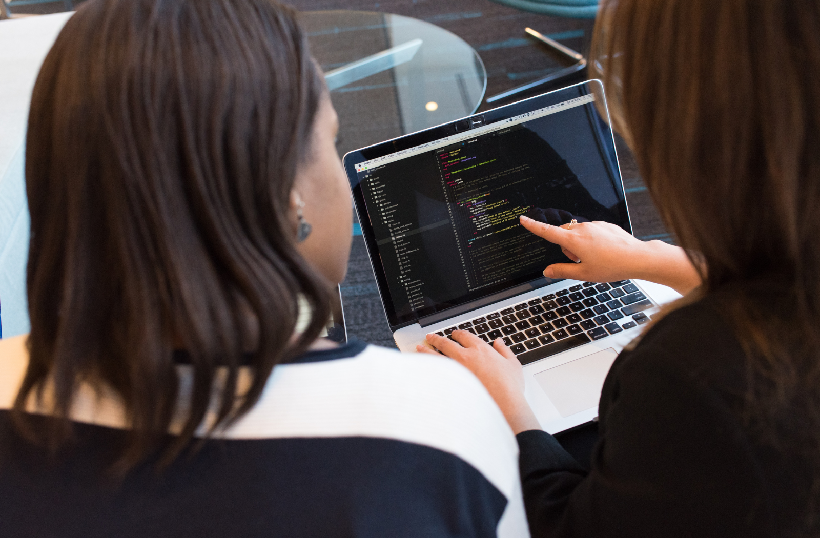 Two women looking at a laptop screen