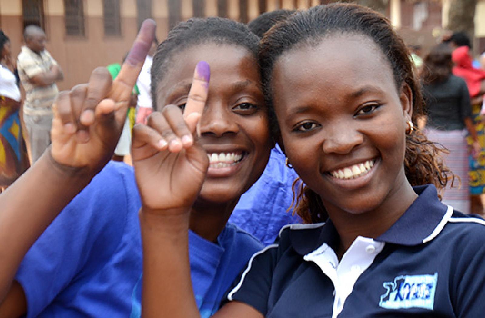 young voters smile at the camera