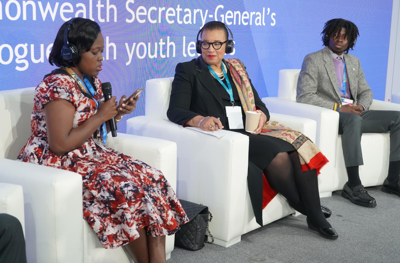 Secretary General and two youth leaders sat on stage