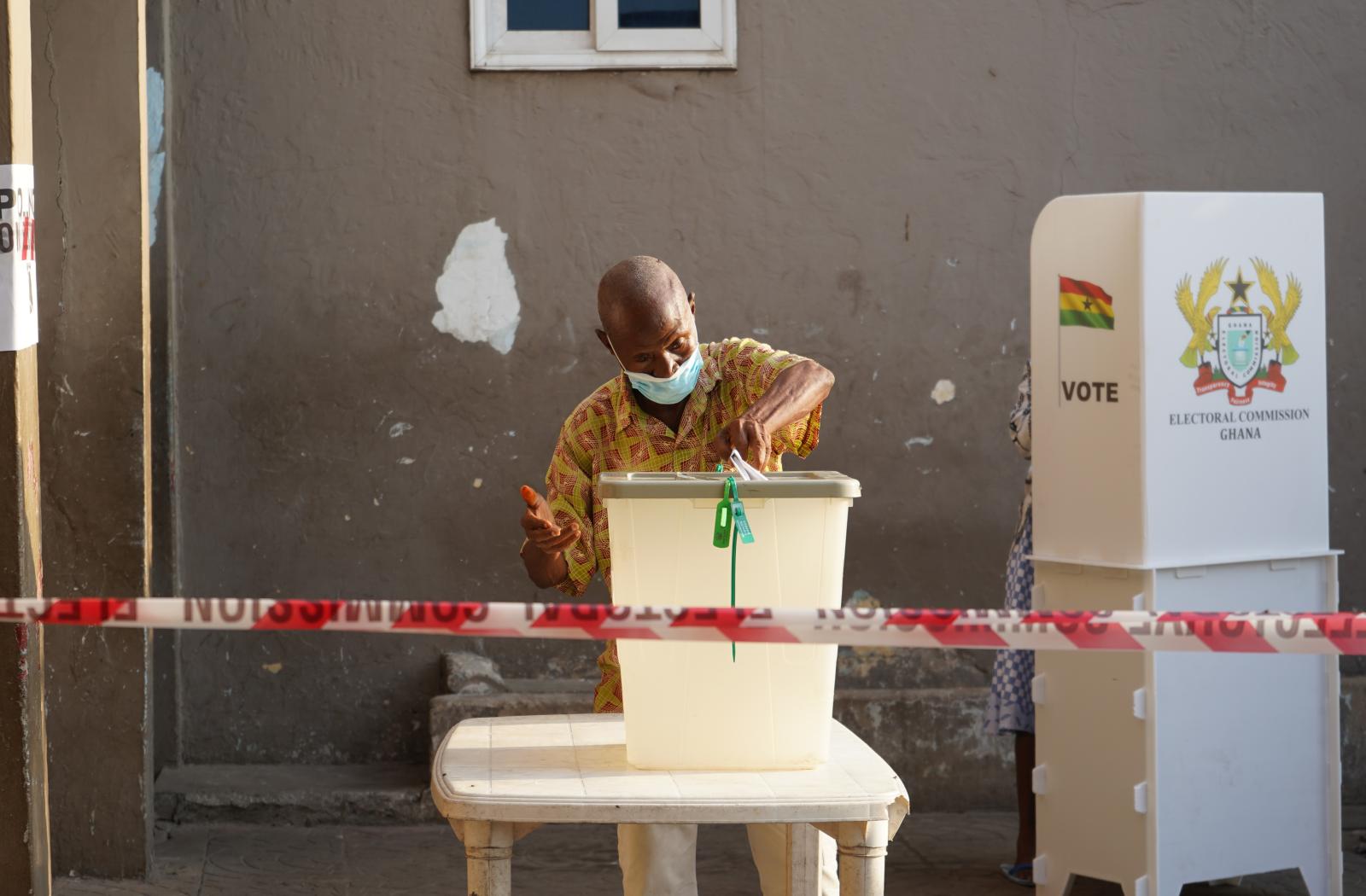 Man putting vote into ballot box